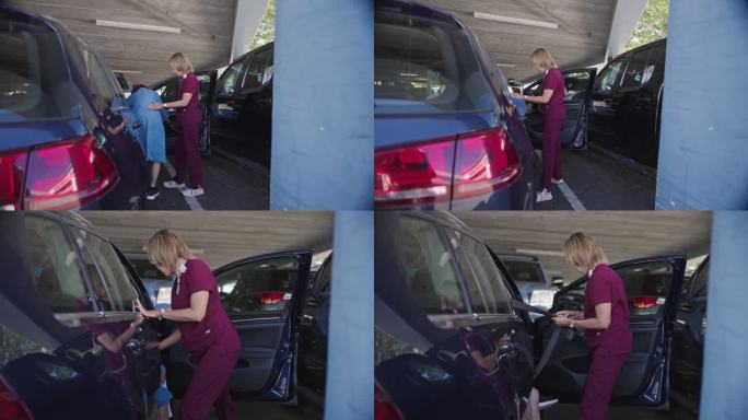 医疗专业人员帮助老年妇女进入停在停车场的汽车