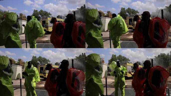 安全救援小组在开始工作前与危险品防护服开会，就化学品泄漏进行头脑风暴