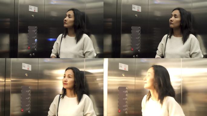 亚洲女人在停车场购物部按电梯按钮。
