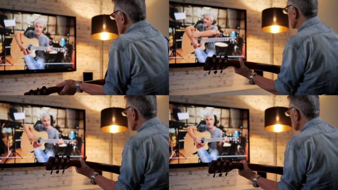 老爷子在网络电视上看教程，爱好吉他概念弹