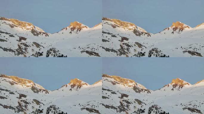 令人惊叹的无人机视角捕捉到日出时雪山的轮廓。