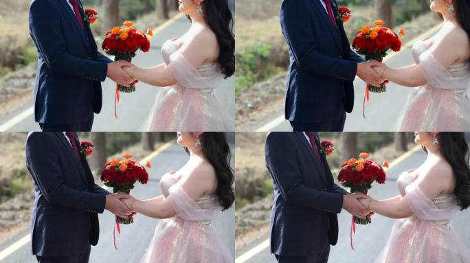 新郎新娘手里的红色鲜花手捧花