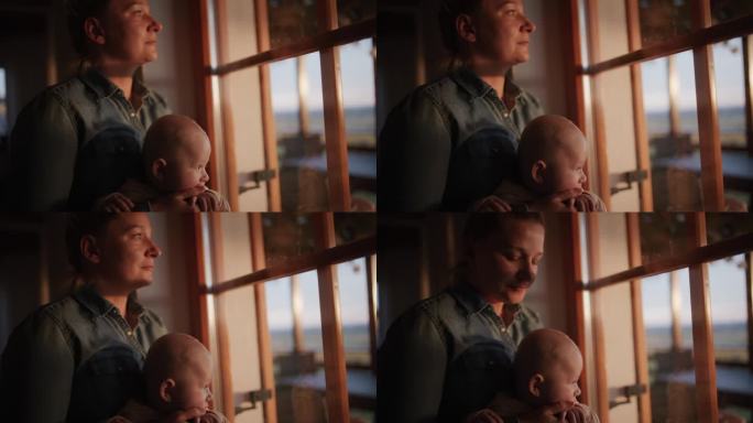 深情瞬间:母亲和婴儿沐浴在窗边的晚霞中