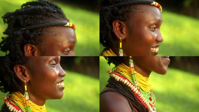 一个快乐的非洲妇女的侧面视图从卡拉莫琼部落在串珠头带和配件。-向下倾斜，近距离拍摄
