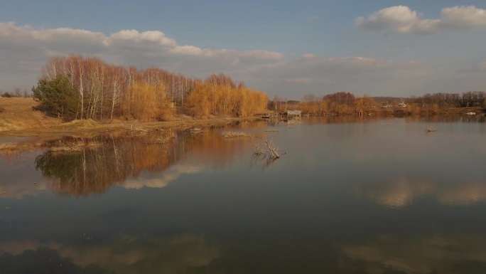 4k鸟瞰图湖附近的小渔夫的房子。房子是高跷的，河流池塘乌克兰