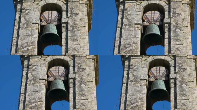 潘横跨教堂，钟楼悬挂在饱经风霜的老石刻塔顶，面对蔚蓝的天空