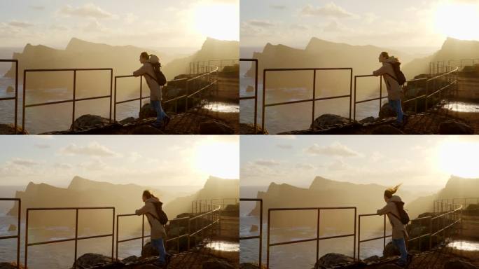 日出时站在高处眺望海洋的女人。回到马德拉岛的自然之旅。