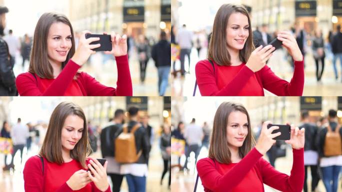 年轻女子在户外用智能手机拍照