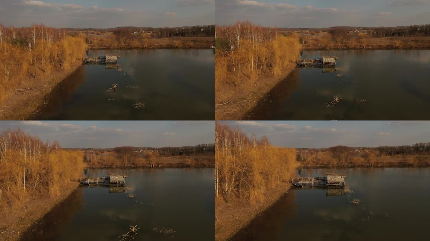 4k鸟瞰图湖附近的小渔夫的房子。房子是高跷的，河流池塘乌克兰