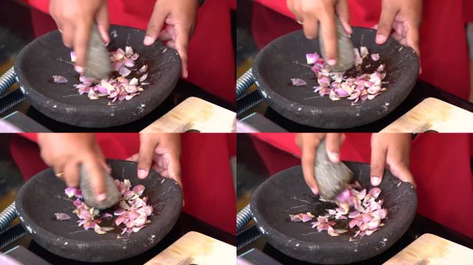 用研钵和杵磨洋葱。印尼厨师在碾碎洋葱