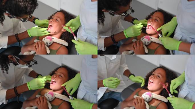 儿科牙医在牙科诊所为一个儿童病人诊治的儿科医生。