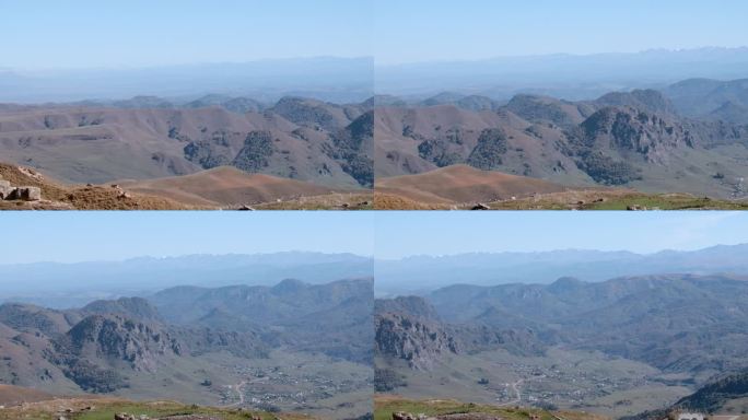 从直升机上拍摄的大山坡。有创造力。灰色的风景，棕色的山脉和小山映衬着头顶上明亮的天空。高品质4k画面