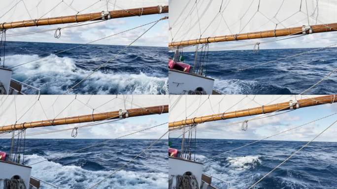 从一艘复古风格的帆船上看德雷克海峡，木船吊杆，大量的绳索，在晴朗的天气里，南大洋的大浪
