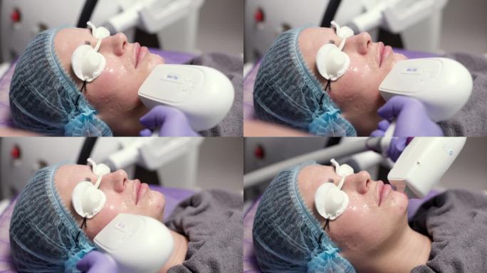 面部LED光疗。用于光动力治疗的LED灯。面部。女孩在做光疗和水疗。程序和放松，休息和皮肤治疗。一个