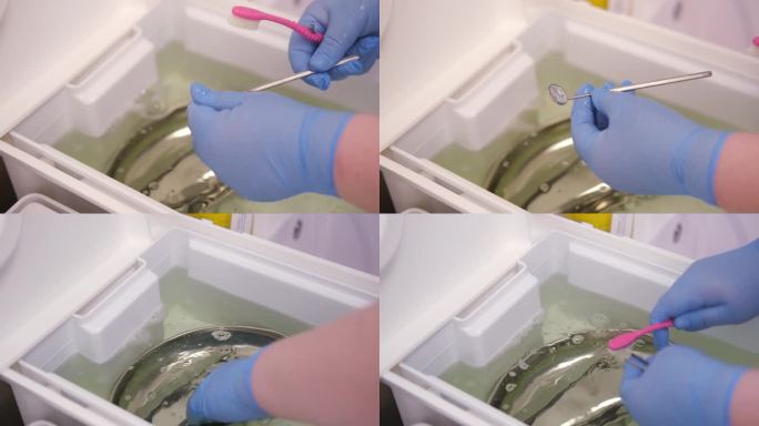 清洁，灭菌和消毒牙科医疗工具。牙科诊所助理在水龙头的流水下用刷子清洗牙科工具。大流行期间的近距离保护