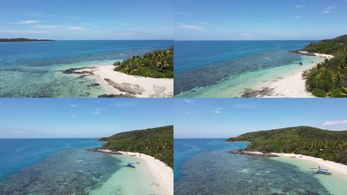 空中无人机视图与天堂斐济岛180度全景。白色的沙滩和棕榈树。船在碧蓝清澈的海水中航行。旅游胜地