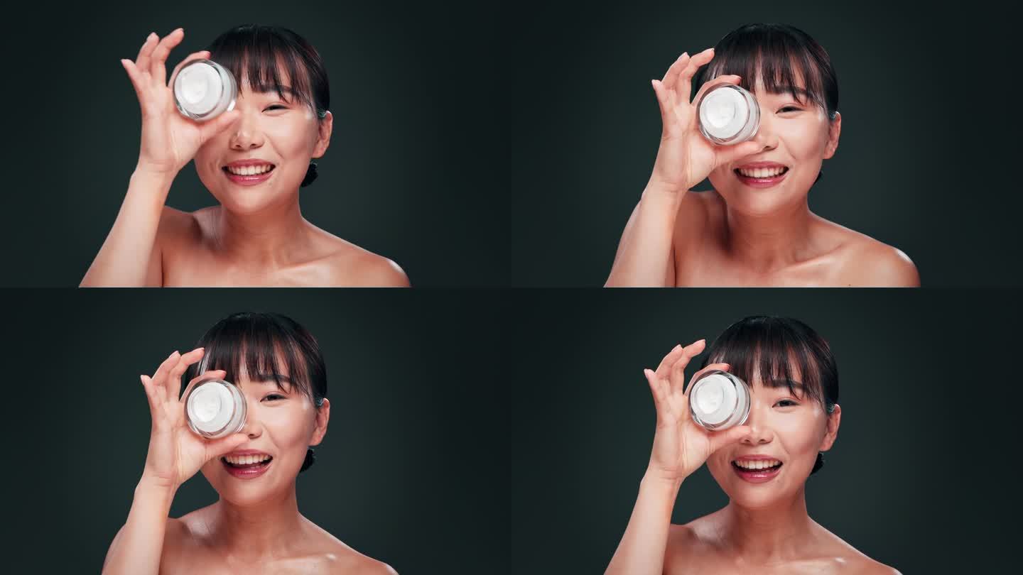 女性，亚洲和美容面霜，面部和皮肤护理与润肤霜，皮肤和健康在灰色背景。抗衰老，乳液容器和眼部产品，化妆