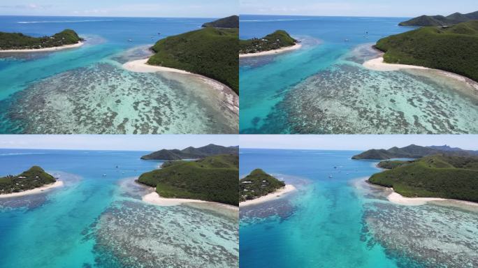 美丽的夏日热带景观天堂海洋岛。绿松石水配珊瑚，白色。沙滩，还有热带的青山。4K无人机视频惊人的海景。