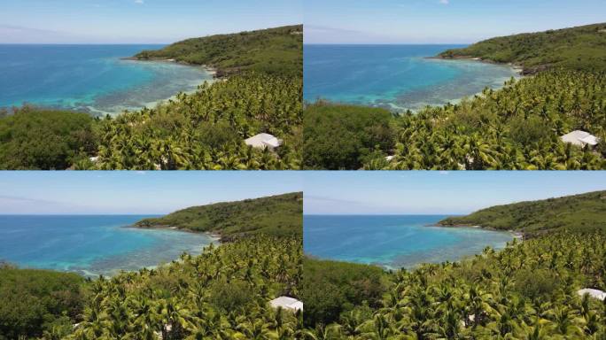 无人机拍摄的斐济德拉瓦卡岛。棕榈树、椰林和其他郁郁葱葱的植被与绿松石般的海水形成鲜明的对比。