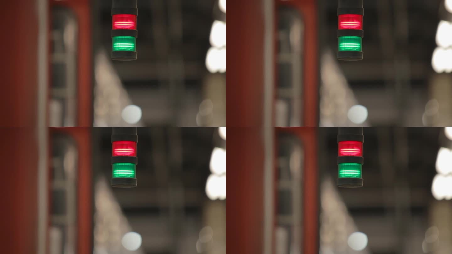 在模糊的火车站背景中，红绿信号灯的特写