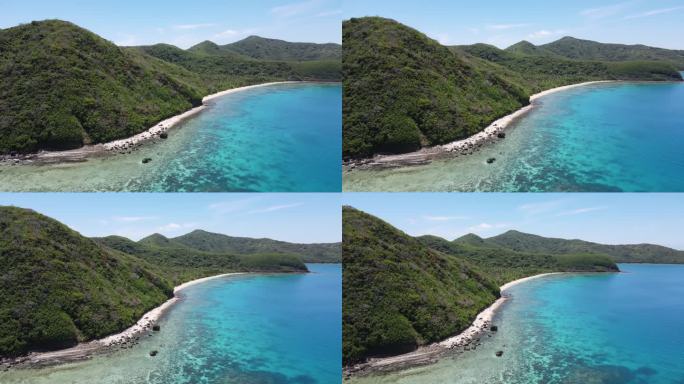 太平洋火山岛Yasawa的鸟瞰图。绿色的山峰和阳光普照的白色沙滩，绿松石般的海水。斐济，南太平洋