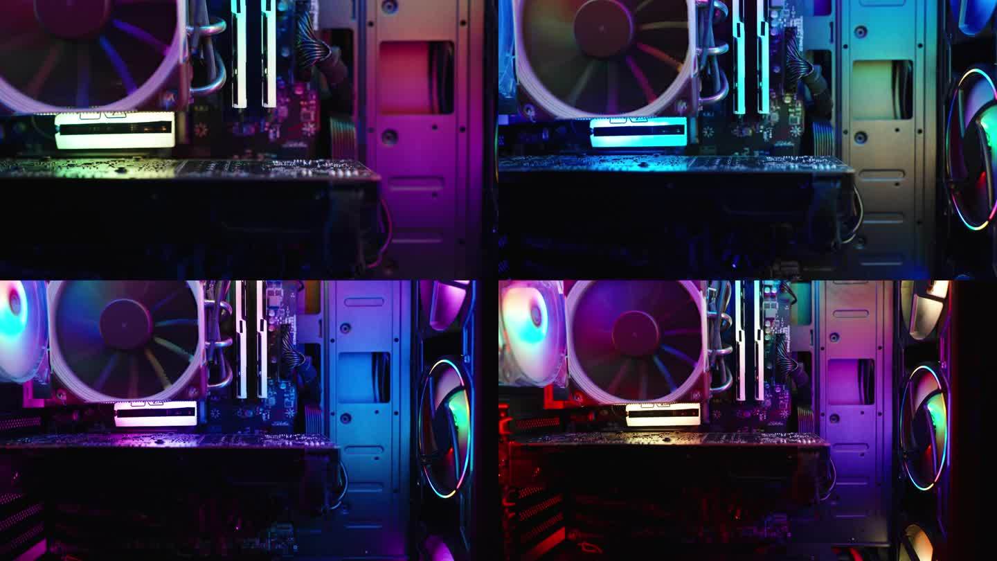 游戏PC机箱内的彩虹RGB照明，组件在黑暗中，变焦。