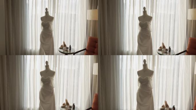 新娘准备时，酒店房间的模特穿着白色长裙。婚礼的细节