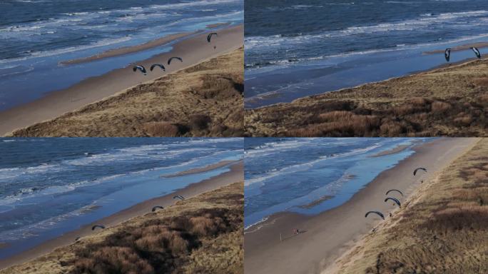 无人机拍摄的滑翔伞在荷兰北部Wijk Aan Zee的沙滩上飞行