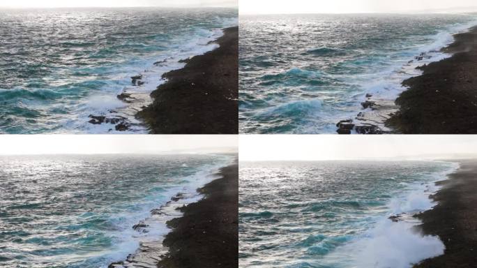 强烈的海浪冲击着岛上被侵蚀的碳酸盐岩，激起阵阵浪花