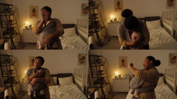 快乐的黑人母亲带着襁褓中的婴儿在卧室里跳舞唱歌