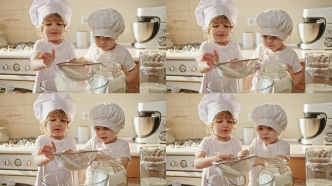 两个戴着厨师帽的孩子在厨房里做饭，微笑着分享