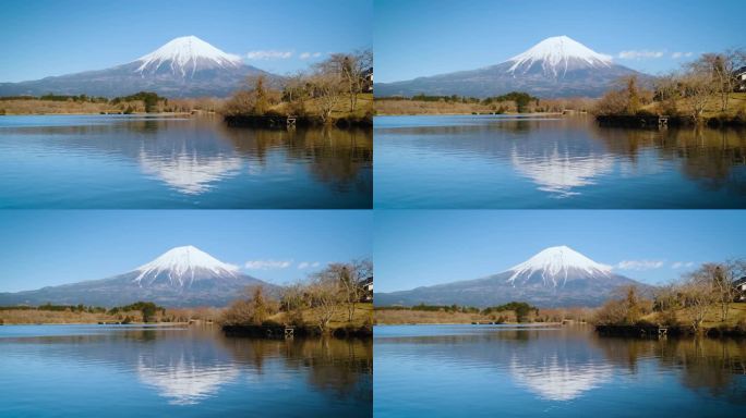 在蓝天的日子里，富士山撞击山脉，倒影在川口湖上，川口湖是游客和旅行者的地标和目的地。冬天宁静的夜晚，