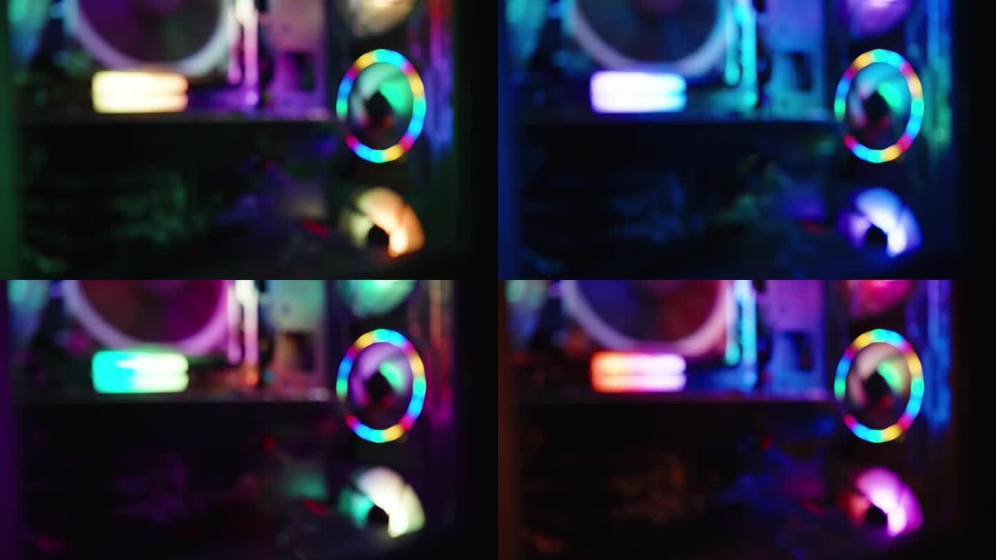 科技视频的背景，个人电脑的内部组件，黑暗中游戏电脑的彩虹灯光。焦距不清。