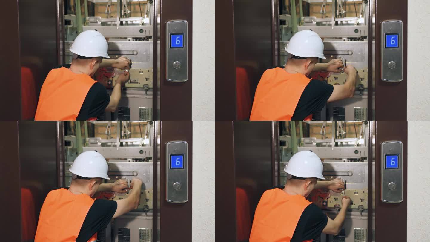 安装复杂的现代化电梯设备，调试电梯部件。一名男性公用事业工人正在修理电梯，电梯门开着。