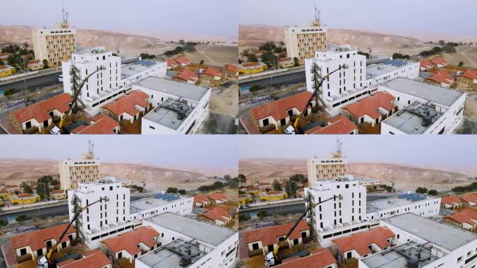 在沙漠里建旅馆。
背景是黄色和棕色的沙山。
无人机拍摄的
4 k