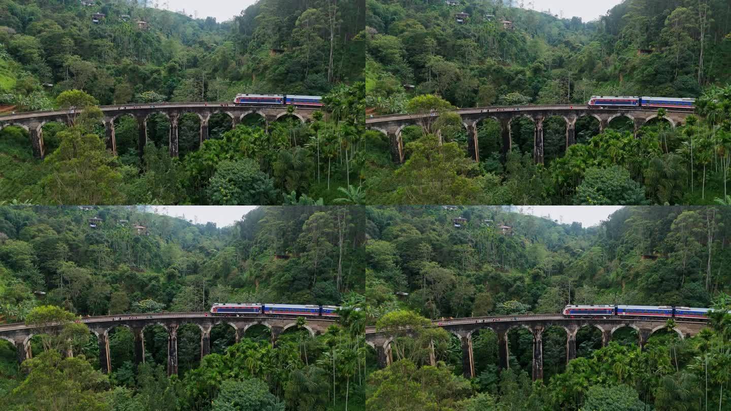 火车经过斯里兰卡九拱桥和茶园的鸟瞰图