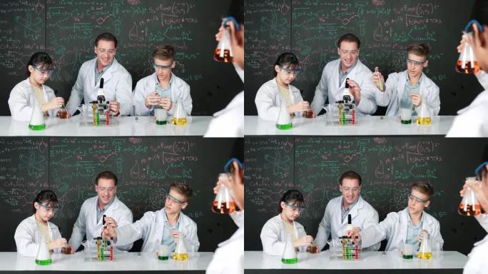 女孩在不同的学生做实验时检查彩色液体。启迪