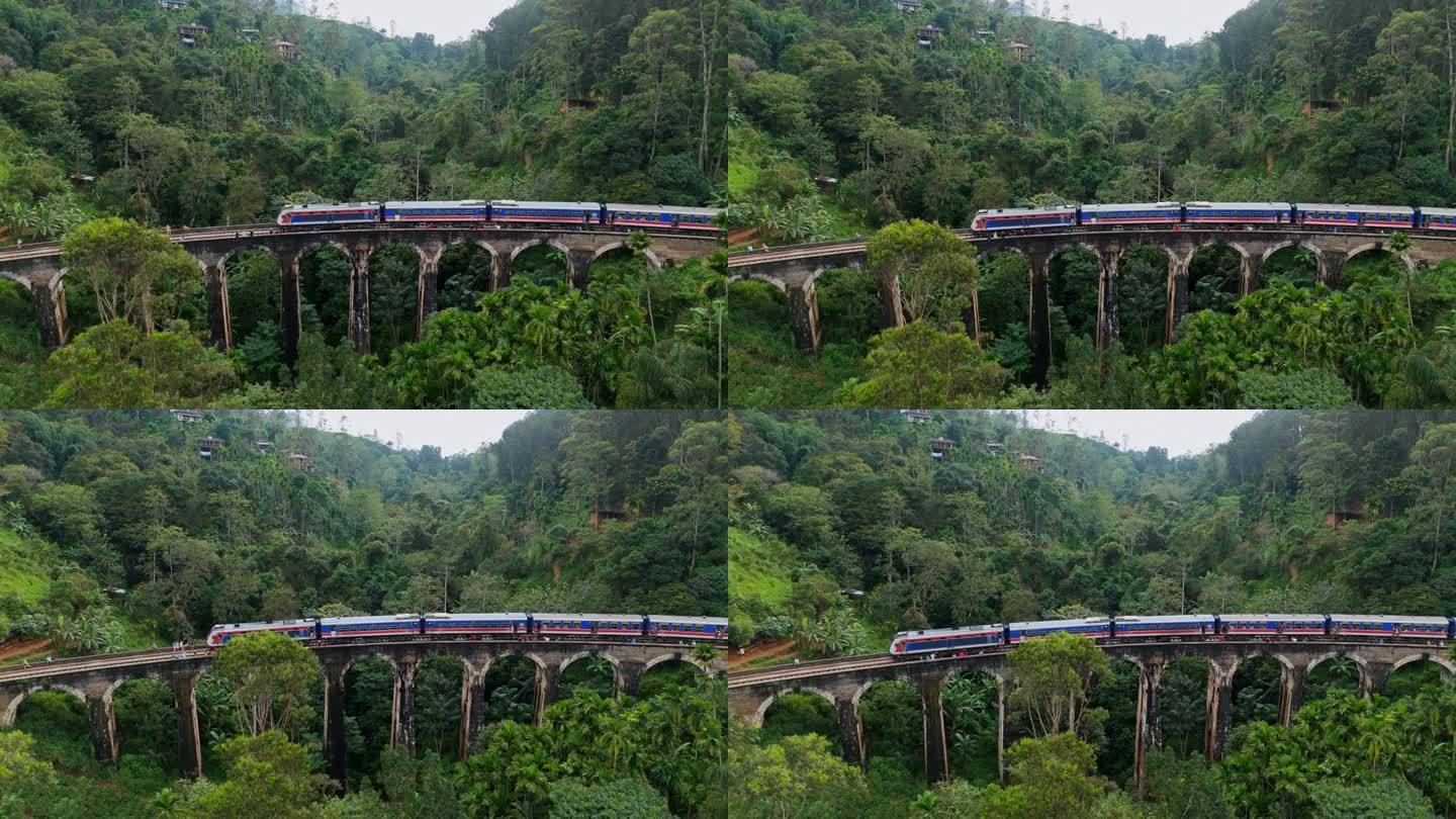 火车经过斯里兰卡九拱桥和茶园的鸟瞰图