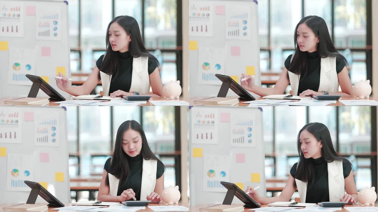年轻的女商人在联合办公空间用她的平板电脑和打印的图表检查数据