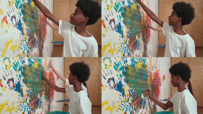 学生用手在彩色的墙壁上作画。网站的看法。启迪