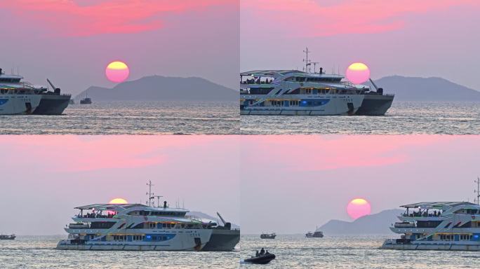 海南三亚橘红色夕阳晚霞行驶的巨型豪华游艇