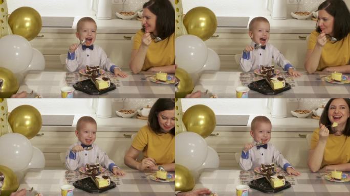 3岁小男孩用蛋糕庆祝生日。在家里举行家庭生日聚会。