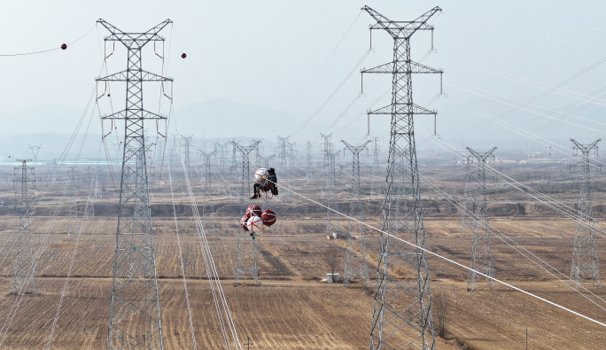 电力工人在高压线路上施工 安装航空警示球