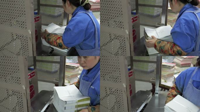 印刷厂里工人在整理印刷好的寒假作业书本3
