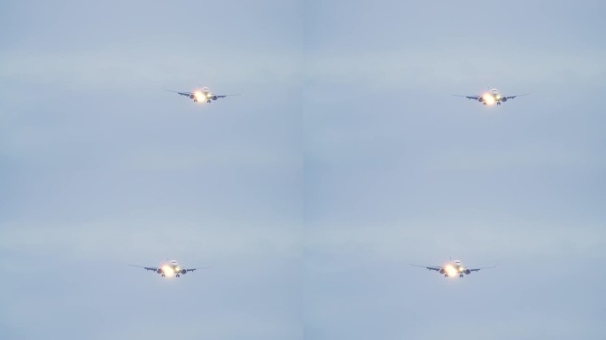 前视图飞行喷气式客机。飞机抵达机场并在黄昏降落