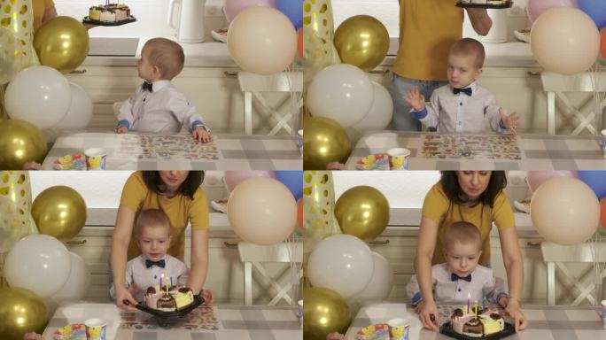 3岁小男孩用蛋糕庆祝生日。在家里举行家庭生日聚会。