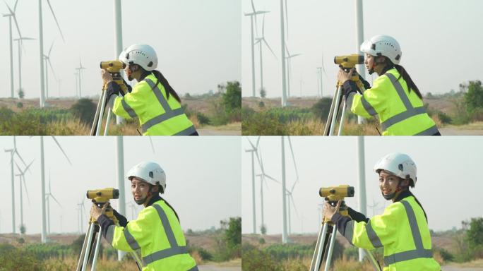 在风力发电厂工作的女工程师使用测量设备水平仪的肖像