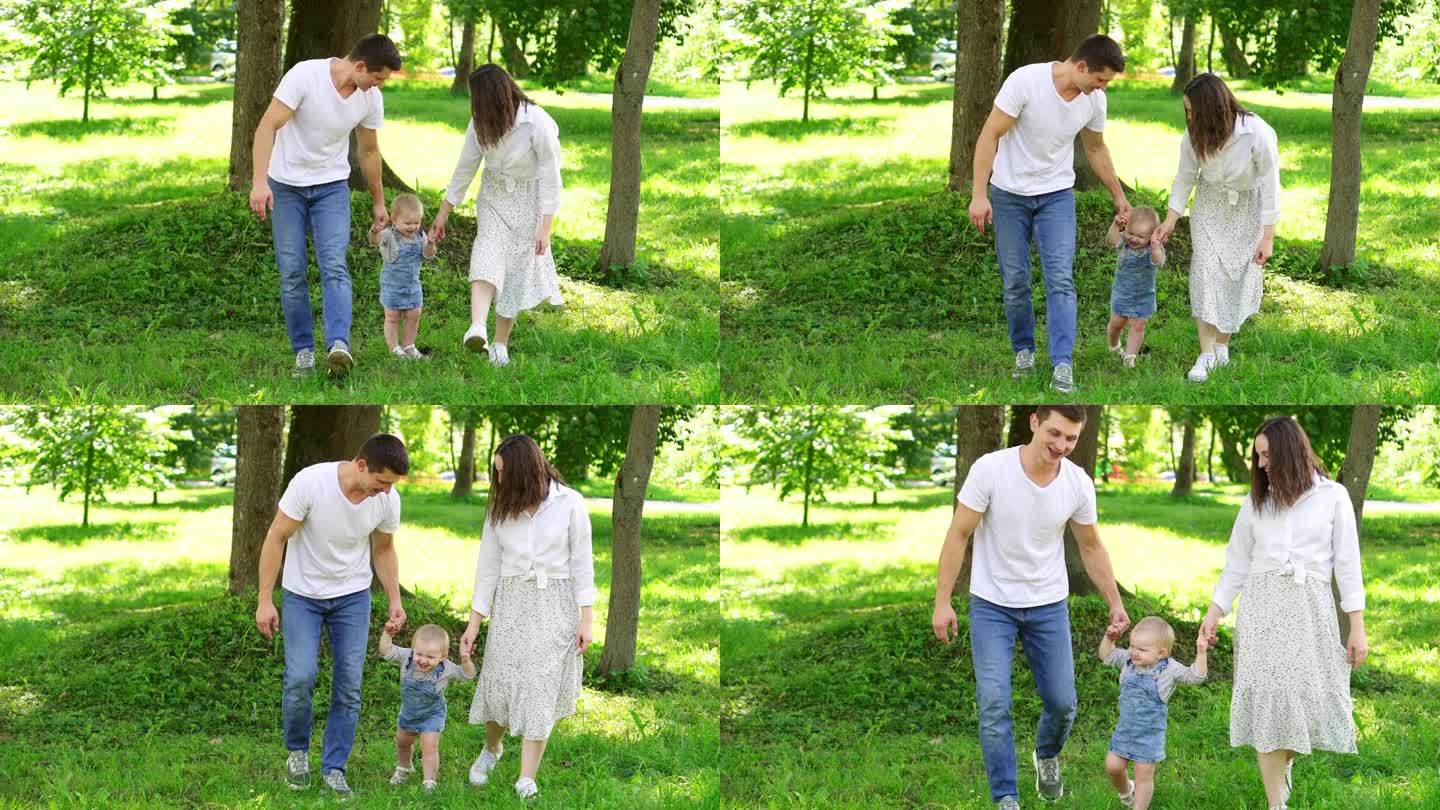 在公园的草地上，父母牵着手教孩子如何走路。学走路，踏出第一步。幸福的家庭