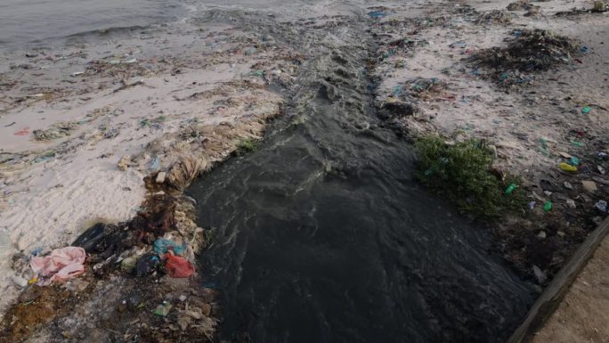 摇上。臭气熏天的污水和塑料污染流入海洋。