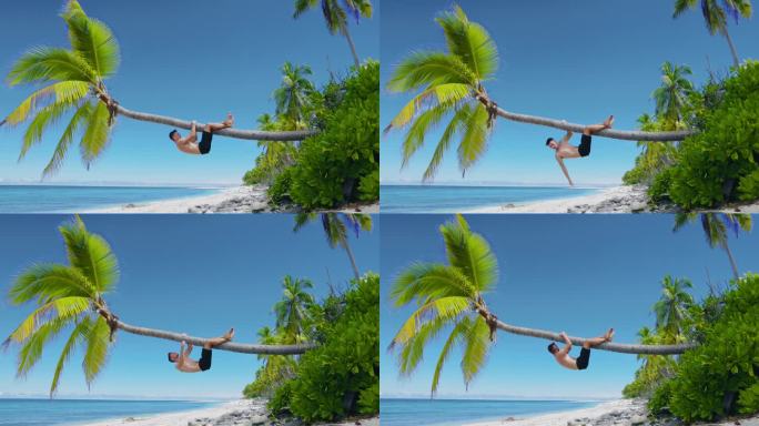 一个年轻人光着膀子在沙滩上放松，爬上一棵椰子树。天堂海滩上的瘦子